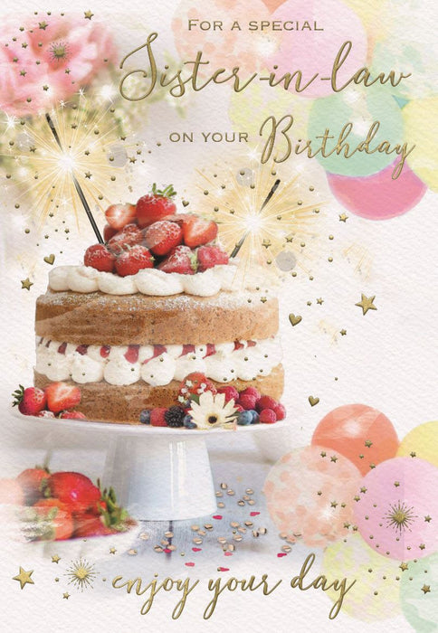 A birthday greeting card for a sister-in-law, featuring a decorated cake on a white pedestal with strawberries and candles, surrounded by balloons, fireworks, and gold script text reading 'For a special Sister-in-law on your Birthday enjoy your day'.