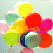 Colorful balloons against a light blue background