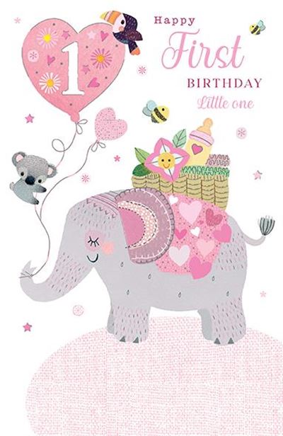 A baby first birthday card featuring a cute pink and gray elephant carrying a basket of baby items, with a pink heart-shaped balloon that says '1' and the text 'Happy First Birthday little one' on a white background.