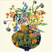 Colorful floral arrangement in a patterned vase on a light beige background
