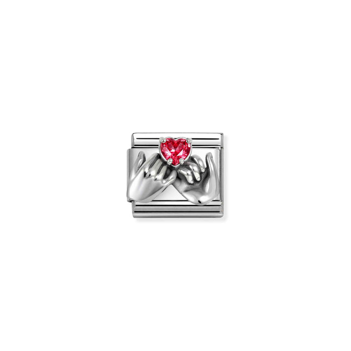 A silver-toned rectangular charm featuring two sculpted hands holding a small red heart-shaped gemstone, centered on a plain white background.