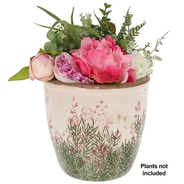 An artificial floral arrangement in a distressed ceramic pot with pink flowers and green foliage, on a white background with a text overlay that says 'Plants not included'.