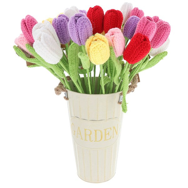 A decorative bouquet of crocheted tulips in pink, red, purple, white, and yellow, arranged in a cream-colored metal bucket with the word 'GARDEN' on the front, set against a plain white background.
