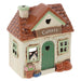 A ceramic cottage-shaped cattery shop ornament with a brown tiled roof, cream-colored walls, a green door, and a sign reading 'Cattery' on the front.