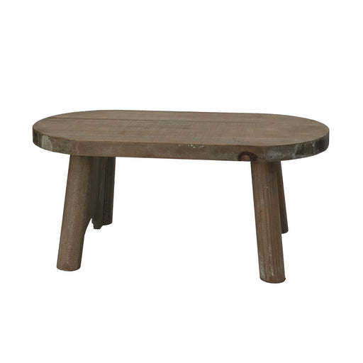 A rustic oval wooden coffee table with a weathered brown finish and three sturdy legs, shown against a plain white background.
