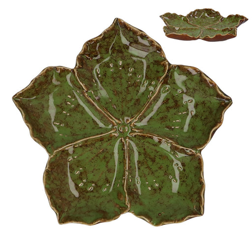 Green ceramic leaf-shaped plate on a white background