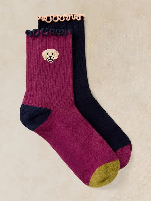 Pair of socks with a dog logo on a beige background