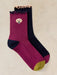 Pair of socks with a dog logo on a beige background
