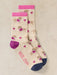 Pair of socks with dog pattern and pink accents on a beige background