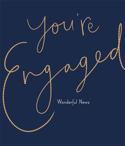 A square navy blue card or sign with elegant script text reading 'you're Engaged' in a gold beaded or dotted outline style, with 'Wonderful News' in smaller white text below.