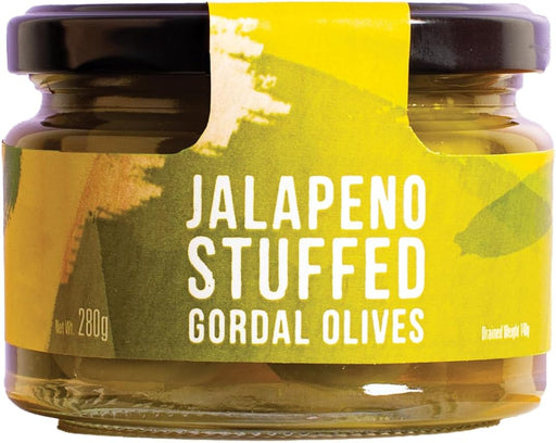A glass jar of Jalapeño Stuffed Gordal Olives with a black lid and a yellow-green label with white text.