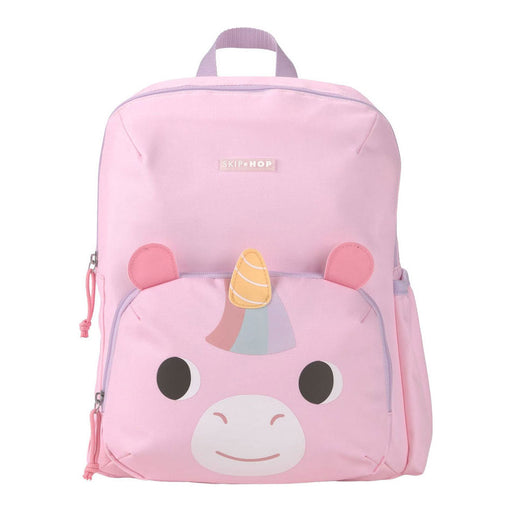 A pink backpack featuring a cartoon unicorn face on the front pocket, with a small striped horn and pink ear details, photographed on a plain white background.