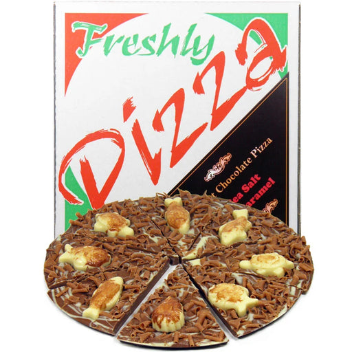 A novelty chocolate pizza shaped and decorated like a real pizza, shown in front of its branded retail box labeled 'Freshly Pizza Chocolate Pizza'. The product is photographed on a plain white background.