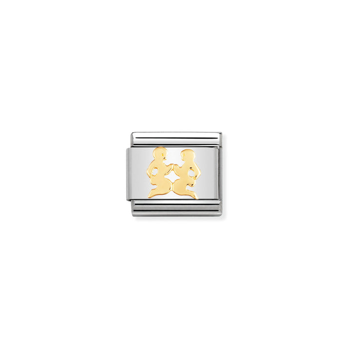 Silver and gold charm on a white background