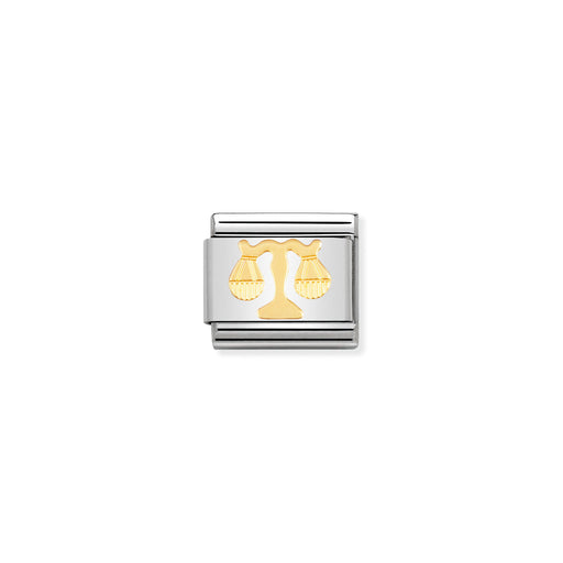 Silver and gold zodiac charm on a white background