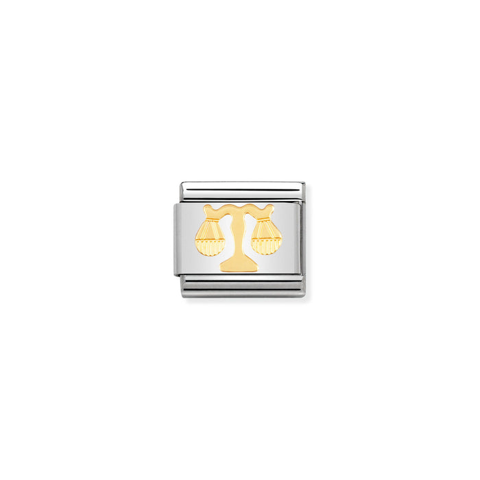 Silver and gold zodiac charm on a white background