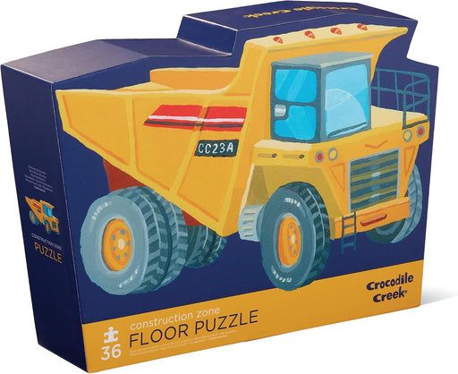 Crocodile Creek Construction Zone Floor Puzzle box featuring a large yellow dump truck illustration on a dark blue background.