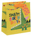 Gift bag with crocodile design and 'Snappy Birthday' text on a yellow background
