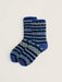 A pair of crew socks with a blue and navy Nordic pattern, featuring light blue and white accents, displayed on a light beige background.