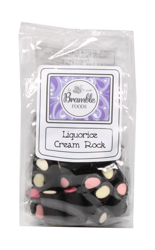 A clear plastic bag of Bramble Foods Liquorice Cream Rock, showing black licorice pieces with cream and pink pieces inside, with a white and purple label on the front.