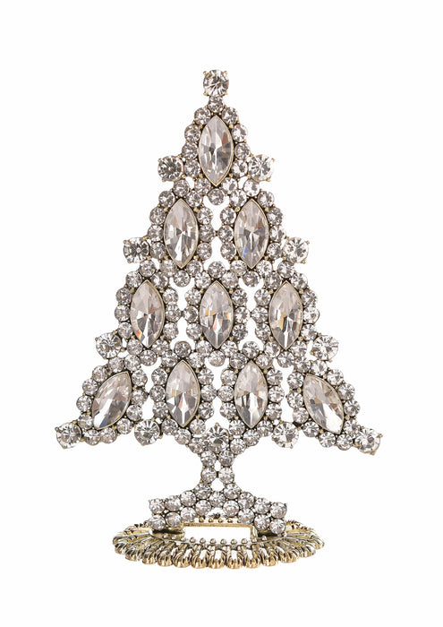 A Christmas tree-shaped brooch or decorative piece made of clear marquise and round crystals set in a silver-toned metal, with a gold-toned base, shown on a plain white background.
