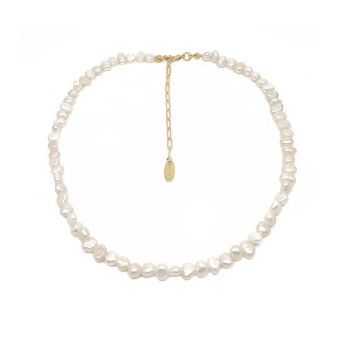 A baroque pearl necklace with a gold chain extender and a small oval gold tag, displayed on a clean white background.
