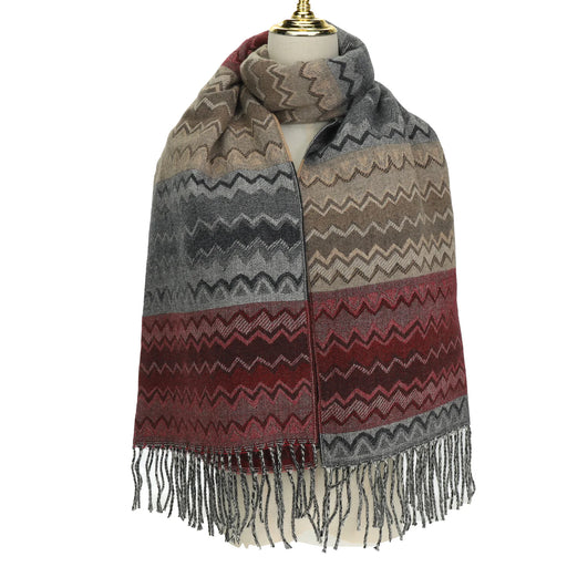 Patterned scarf with fringes on a mannequin against a white background