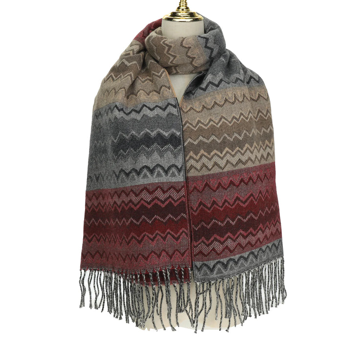 Patterned scarf with fringes on a mannequin against a white background