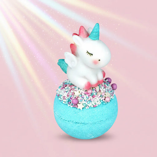 Unicorn-shaped bath bomb with colorful sprinkles on a pastel background