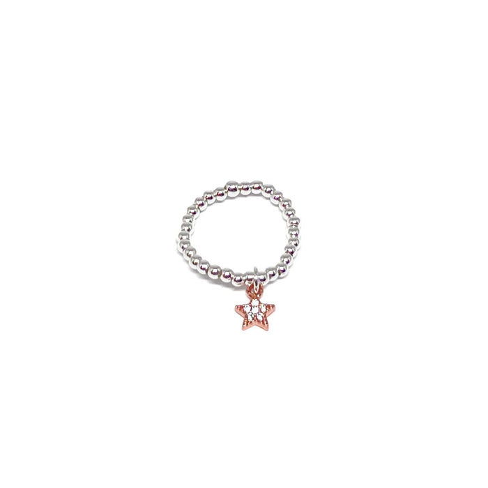A silver beaded stretch ring featuring a dangling rose gold star charm with a clear rhinestone center, shown on a plain white background.