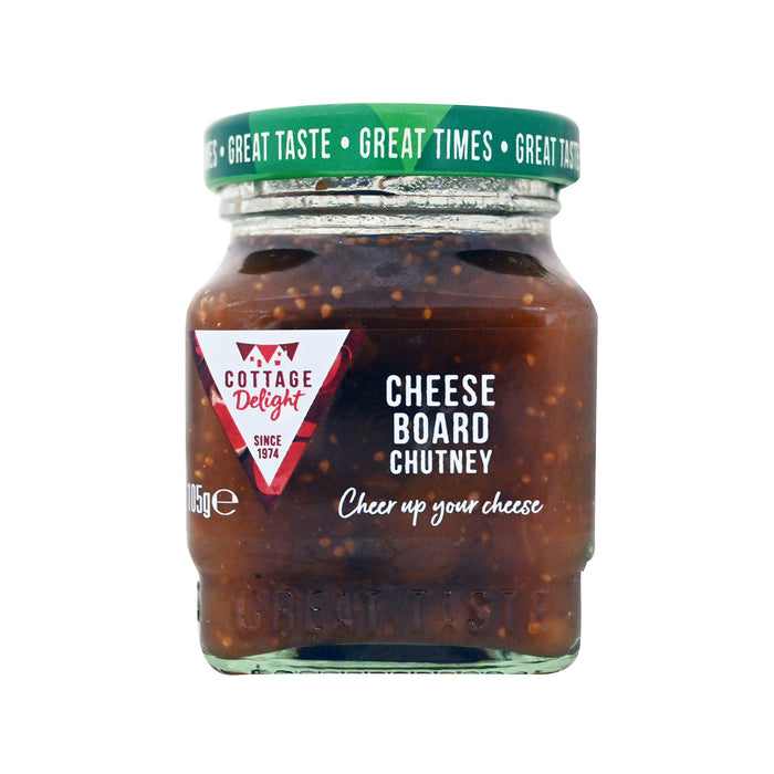 A glass jar of Cottage Delight Cheese Board Chutney with a green lid and a red and white brand label, shown on a plain white background.