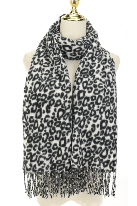 Leopard print scarf with fringe on a mannequin against a white background
