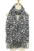 Leopard print scarf with fringe on a mannequin against a white background