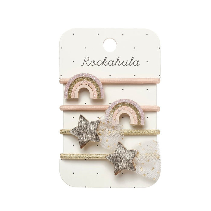 Set of hair clips with rainbow and star designs on a Rockahula branded card.