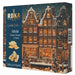 Roka Gouda Cheese Crisps and Sticks limited edition box, featuring a dark blue left panel with product text and biscuit imagery, and a right panel showing a snowy European town scene at night with warm glowing windows.